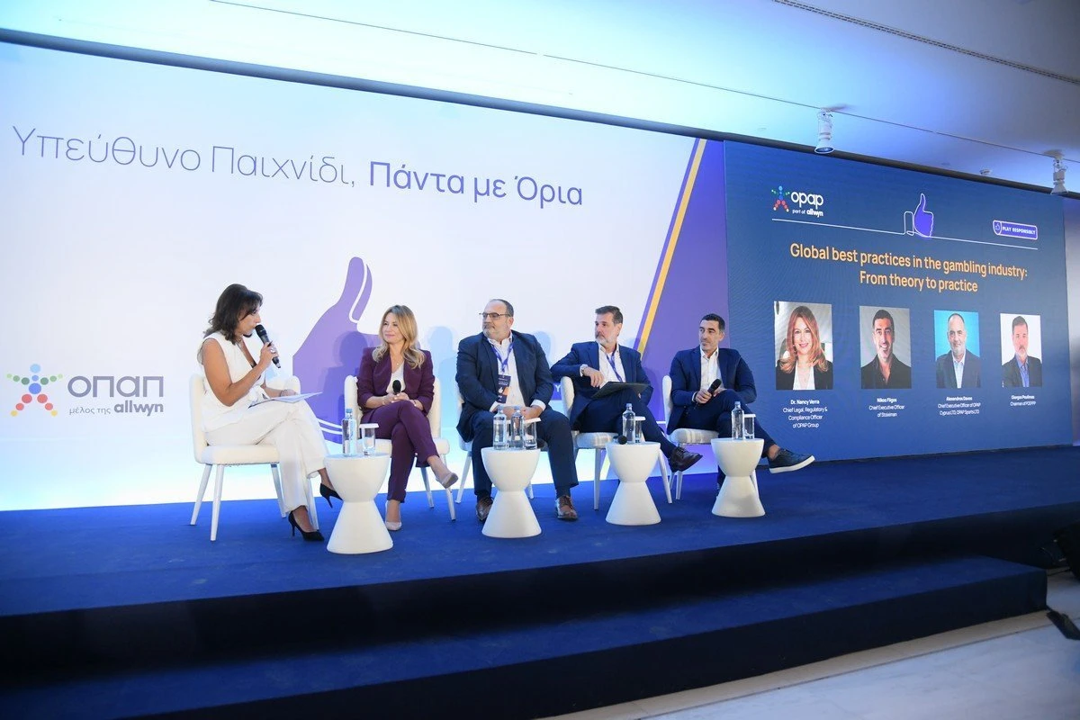 Μαίρη Παπακωνσταντίνου, Δρ. Νάνση Βέρρα, Αλέξανδρος Ντάβος, Γιώργος Πουλημάς, και Νίκος Φλίγκος στο πάνελ «Βέλτιστες πρακτικές στον κλάδο των τυχερών παιγνίων-Από τη θεωρία στην πράξη» Μαίρη Παπακωνσταντίνου, Δρ. Νάνση Βέρρα, Αλέξανδρος Ντάβος, Γιώργος Πουλημάς, και Νίκος Φλίγκος στο πάνελ «Βέλτιστες πρακτικές στον κλάδο των τυχερών παιγνίων-Από τη θεωρία στην πράξη»